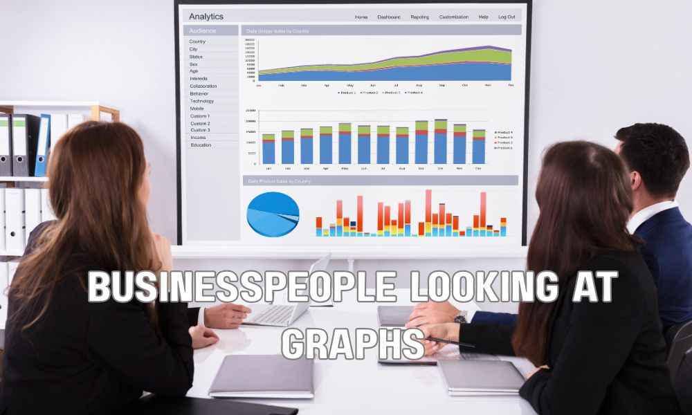 Businesspeople Looking At Graphs
