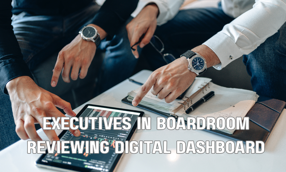 Executives In Boardroom Reviewing Digital