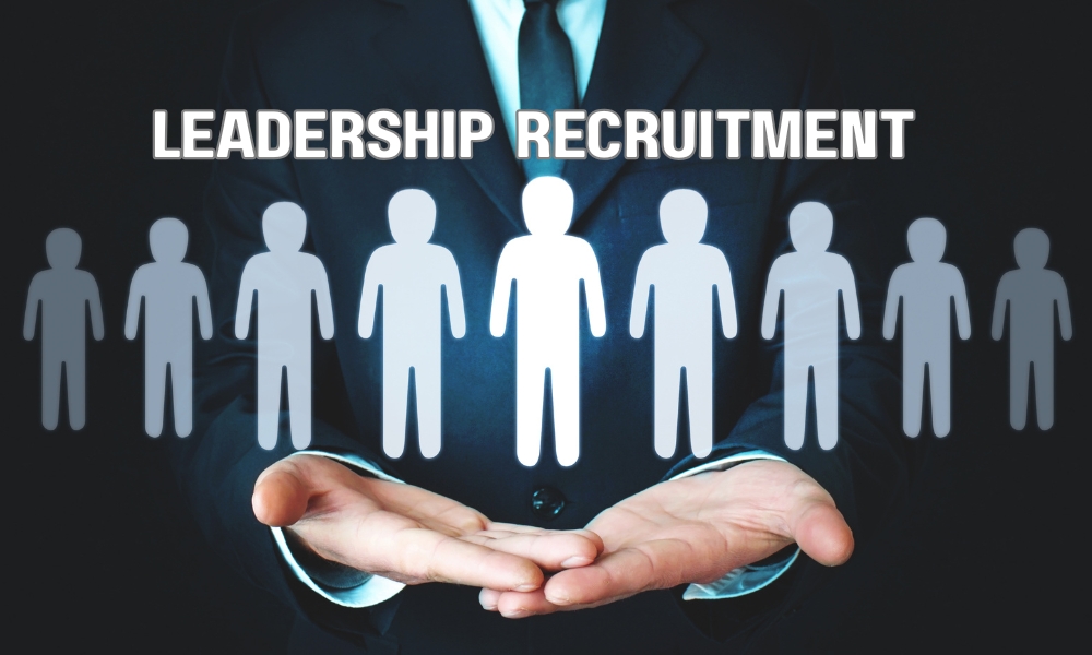 Executive search consultants evaluating senior leadership candidates during a corporate recruitment meeting.