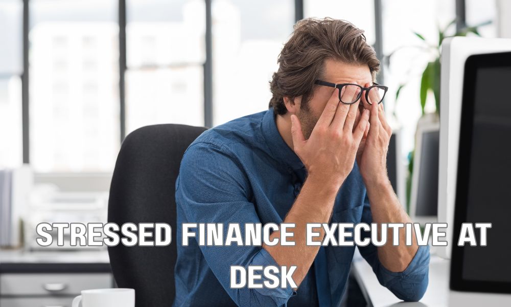 Stressed Finance Executive At Desk