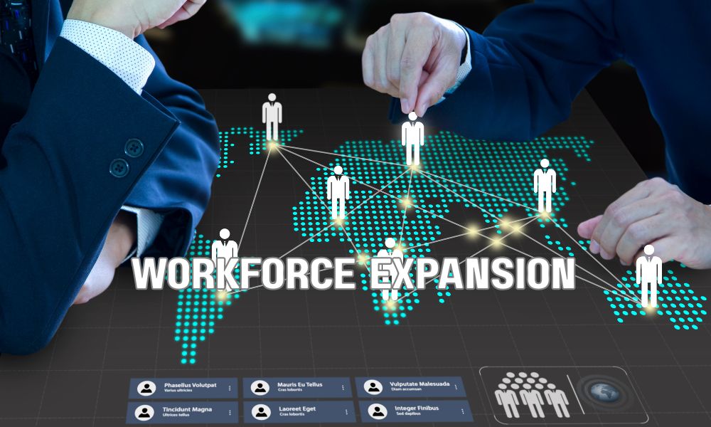 Corporate hiring managers discussing workforce expansion through a coordinated cluster hiring initiative.